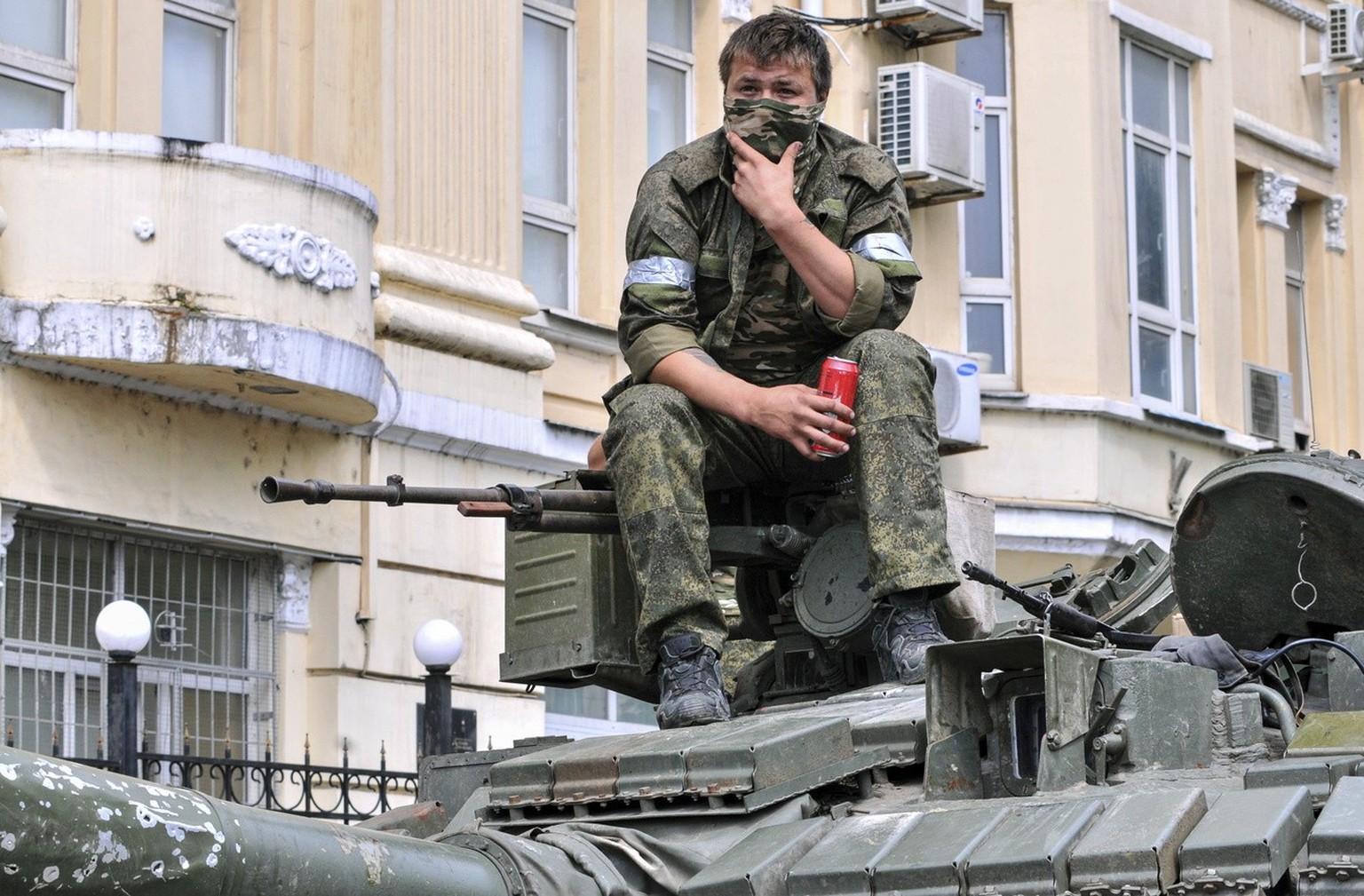 epa10709149 A soldier of the private military company (PMC) Wagner Group sits on a tank blocking a street in the center of Rostov-on-Don, South Russia, June 24, 2023. Security and armored vehicles were ...