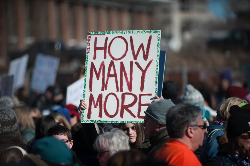 epa06626682 A participant holds a sign &#039;How Many More&#039; during the March For Our Lives in Philadelphia, Pennsylvania, USA, 24 March 2018. March For Our Lives was organized in response to the  ...