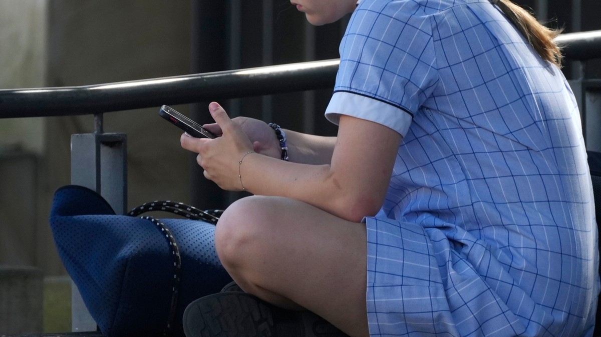 FILE - A young girl uses her phone while sitting on a bench in Sydney, Nov. 8, 2024. (AP Photo/Rick Rycroft, File)
Australia Social Media