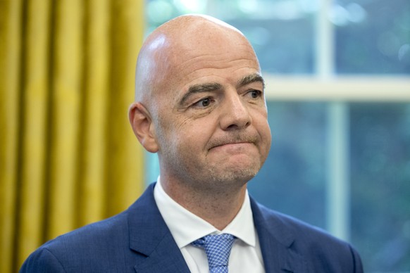 epa06979478 President of FIFA Gianni Infantino listens to US President Donald J. Trump deliver remarks during their meeting in the Oval Office of the White House in Washington, DC, USA, 28 August 2018 ...