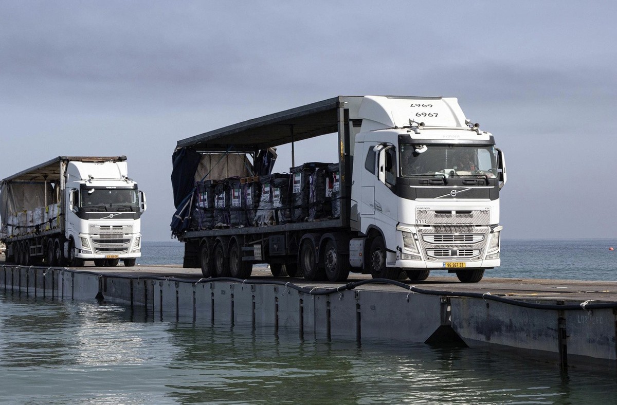 FILE - This image provided by the U.S. Army shows trucks loaded with humanitarian aid from the United Arab Emirates and the United States Agency for International Development cross the Trident Pier be ...