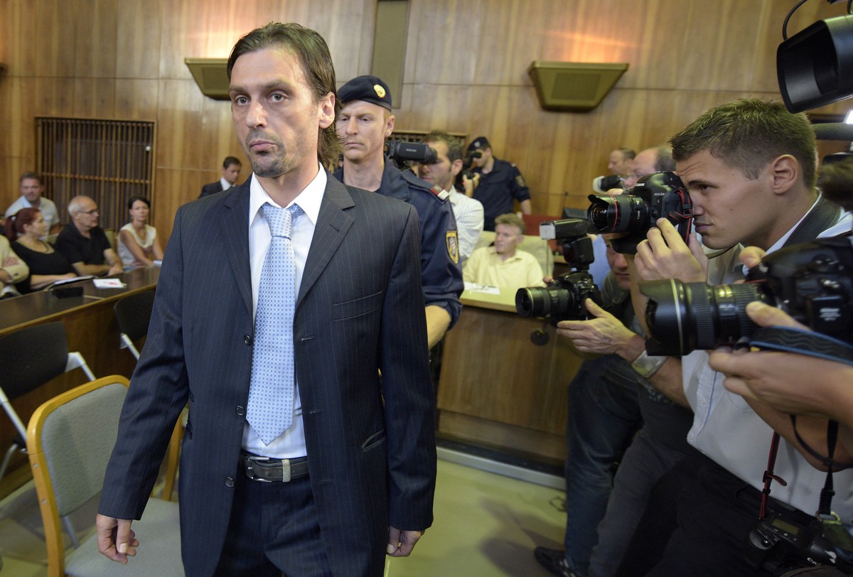 Former soccer player Sanel Kuljic arrives for the first round of a trial at the main court in Graz, Austria, Friday, Aug. 8, 2014. Five former players and five other suspects are set to appear in a cr ...