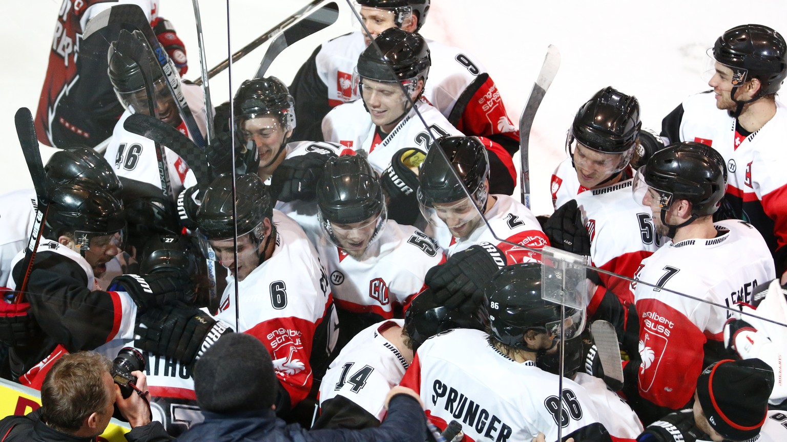 Fribourg&#039;s Yannick Rathgeb (center, hidden) celebrates his winning goal with team mates during the ice hockey Champions League match 1/8 Final between HC Fribourg-Gotteron and KalPa Kuopio of Fin ...