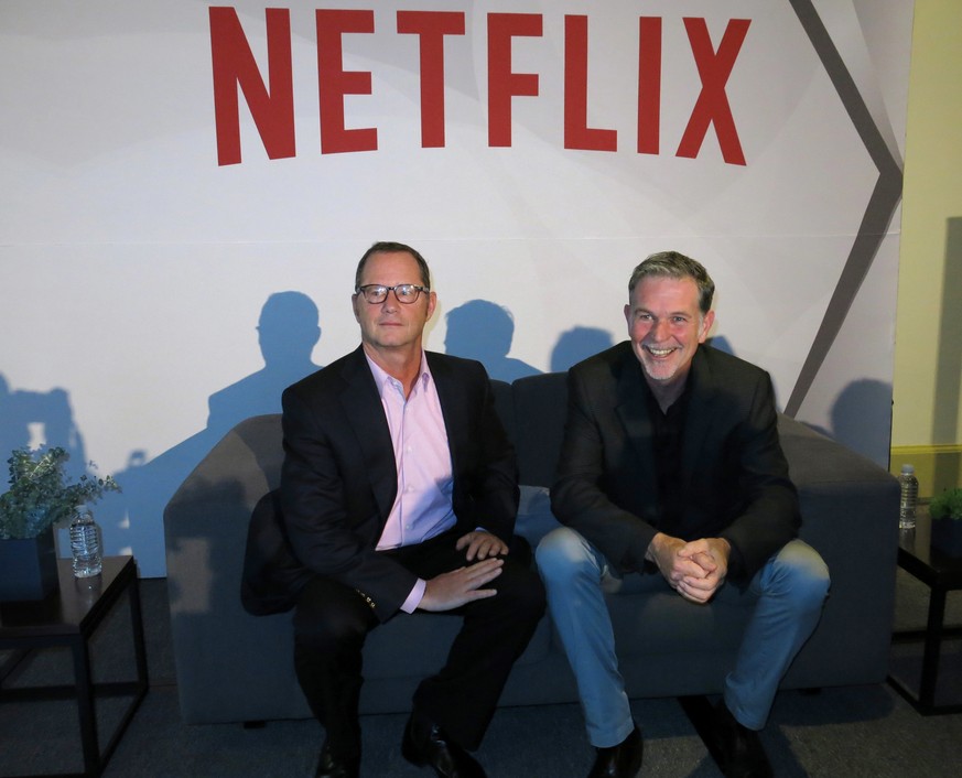 FILE - In this Nov. 24, 2014 file photo, Reed Hastings, CEO and founder of Netflix, right, sits with Jonathan Friedland, global director of communications, as they pose for a portrait during a press c ...