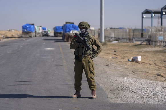 An Israeli soldier stands guard on the Palestinian side of the Kerem Shalom crossing between southern Israel and Gaza, Thursday, Dec. 19, 2024. (AP Photo/Ohad Zwigenberg)