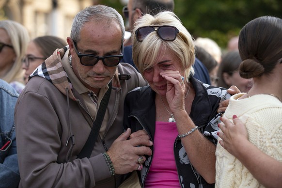 Members of the public take part in a vigil near the scene in Hart Street, in Southport, England, Tuesday, July 30, 2024, where three children died and eight were injured in a knife attack during a Tay ...