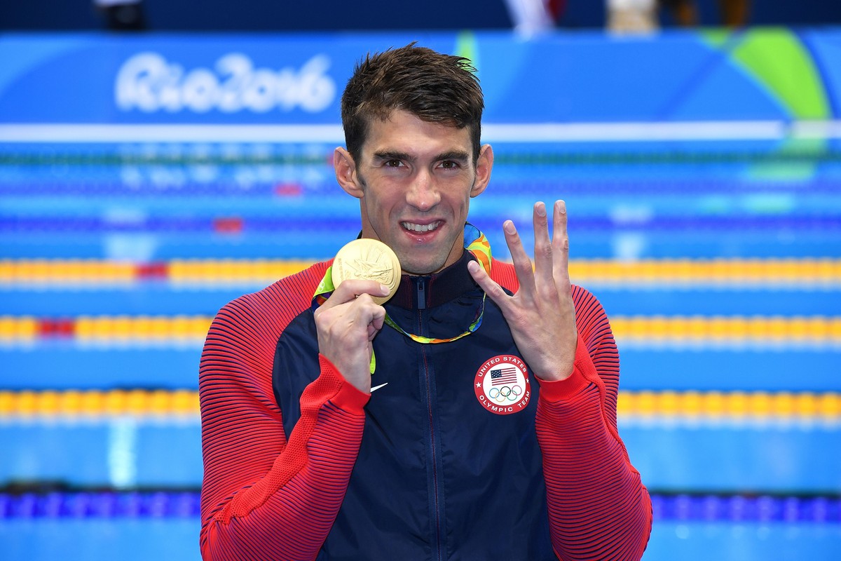epa05476075 Michael Phelps of USA celebrates his fourth Rio 2016 gold medal during the medal ceremony for the men's 200m Individual Medley Final race of the Rio 2016 Olympic Games Swimming events ...