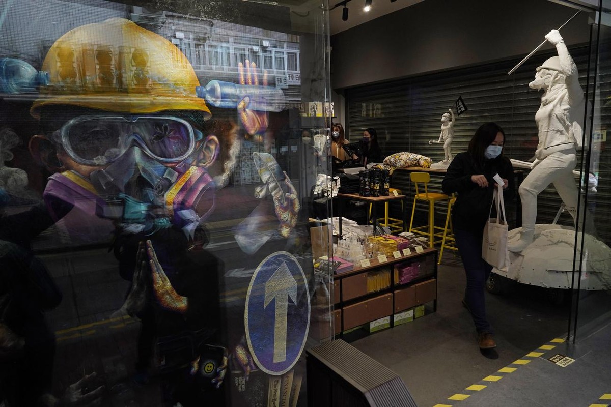 A portrait and the statues named "Lady Liberty Hong Kong," which were inspired by the outfit of anti-extradition law protesters, are displayed at a local retail chain store for children' ...