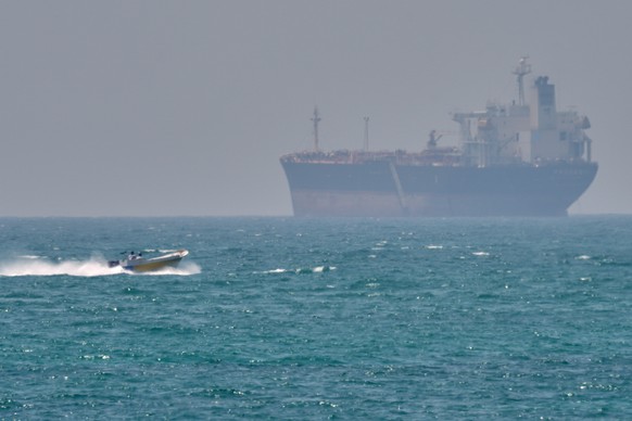 A boat sails past a tanker anchored on the Strait of Hormuz off the coast Qeshm island, Iran, Saturday, April 18, 2026. (AP Photo/Asghar Besharati)
Iran War