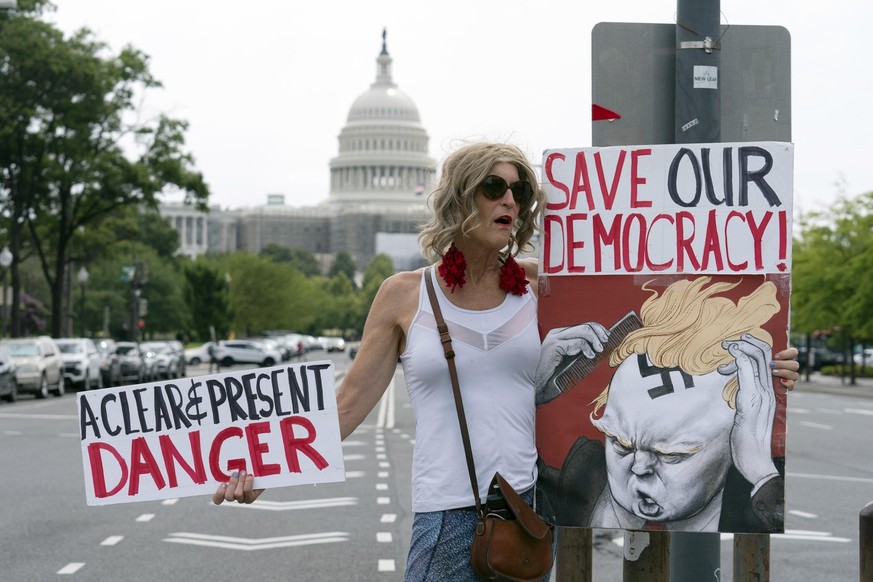 epa10783256 A small group of protesters gather outside the entrance to the E. Barrett Prettyman United States Courthouse, where Judge Tanya Sue Chutkan will arraign former US President Donald J. Trump ...