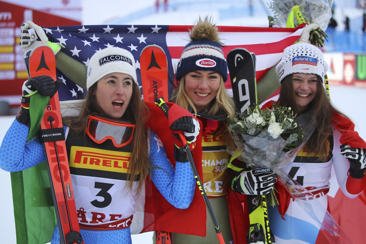 United States' Mikaela Shiffrin, center, winner of the women's super G, celebrates with second-placed Italy's Sofia Goggia, left, and third-placed Switzerland's Corinne Suter, at t ...