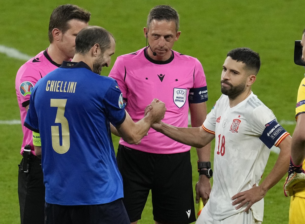 Italy's Giorgio Chiellini shakes hands with Spain's Jordi Alba ahead of a penalty shoot out during the Euro 2020 soccer championship semifinal between Italy and Spain at Wembley stadium in L ...
