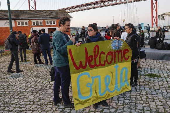 Climate activists wait for the arrival of Greta Thunberg in Lisbon, Tuesday, Dec 3, 2019. Climate activist Greta Thunberg has arrived by catamaran in the port of Lisbon after a three-week voyage acros ...