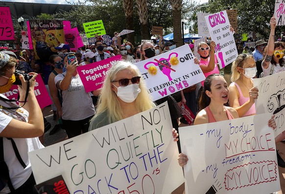 Participants wave signs as they walk back to Orlando City Hall during the March for Abortion Access on Saturday, Oct. 2, 2021, in Orlando, Fla. (Chasity Maynard/Orlando Sentinel via AP)