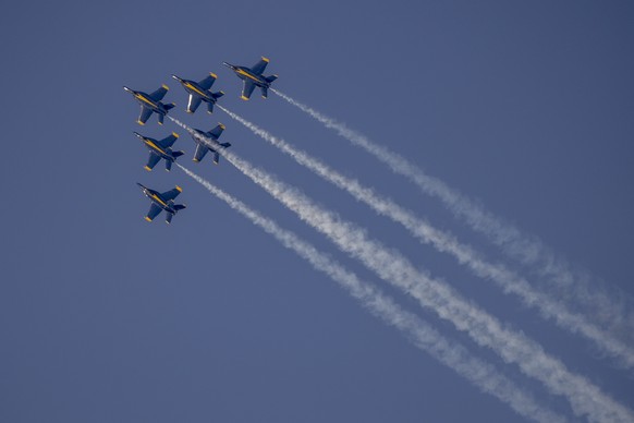 F/A-18 Super Hornets belonging to the U.S. Navy Flight Demonstration Squadron, the Blue Angels, fly in formation during a practice flight ahead of San Francisco Fleet Week, as seen from the Fairmont H ...