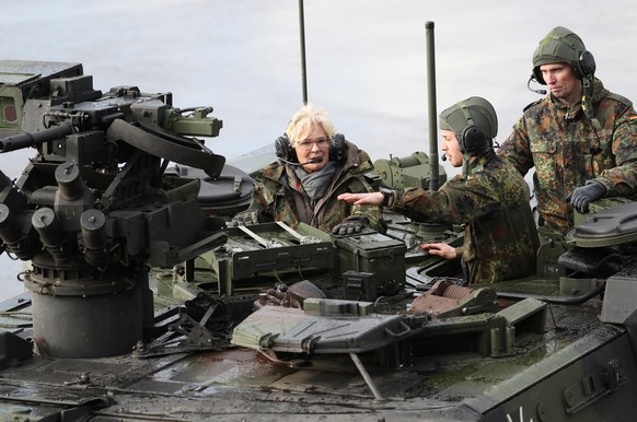 epa09735824 German Minister of Defense Christine Lambrecht (L) takes a ride on a transport vehicle type Boxer during her visits at the 9th Panzerlehr Brigade of the German Bundeswehr in Munster, north ...