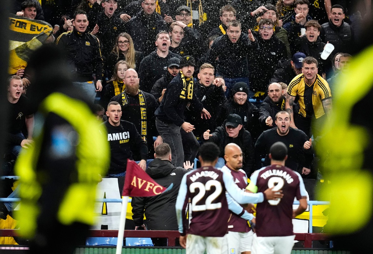 Young Boys' fans react as Aston Villa's Donyell Malen, center, celebrates after scoring the opening goal during the Europa League soccer match between Aston Villa and Young Boys in Birmingha ...