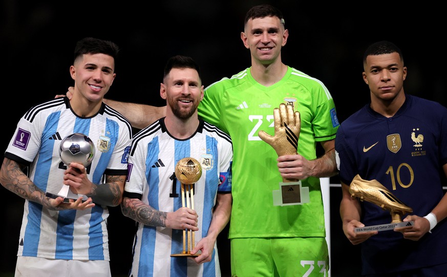 epa10373130 (from L) FIFA 2022 Young Player award winner Enzo Fernandez of Argentina, FIFA 2022 Best Player award winner Lionel Messi of Argentina, FIFA 2022 Golden Glove award winner Emiliano Martine ...