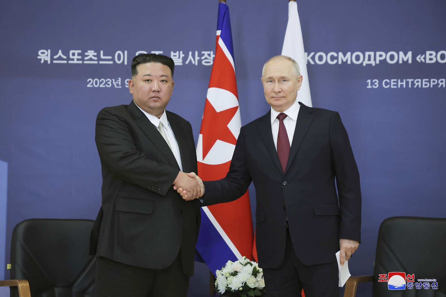 In this North Korean government photo, North Korean leader Kim Jong Un (left) and Russian President Vladimir Putin shake hands as they pose for a photo before their speech at the Vostoch...