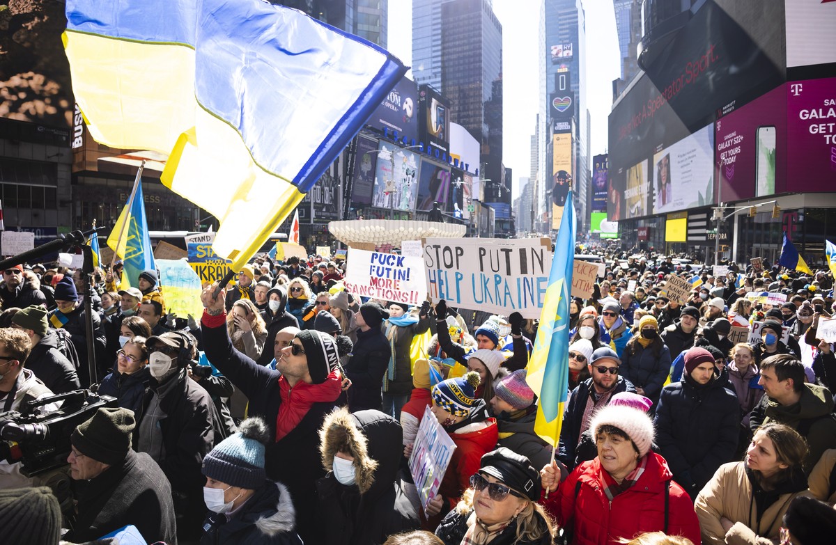 epa09787614 People gather in Times Square for a rally in support of the Ukrainian people and to protest Russia's invasion of the country this week in New York, New York, USA, 26 February 2022. Ru ...