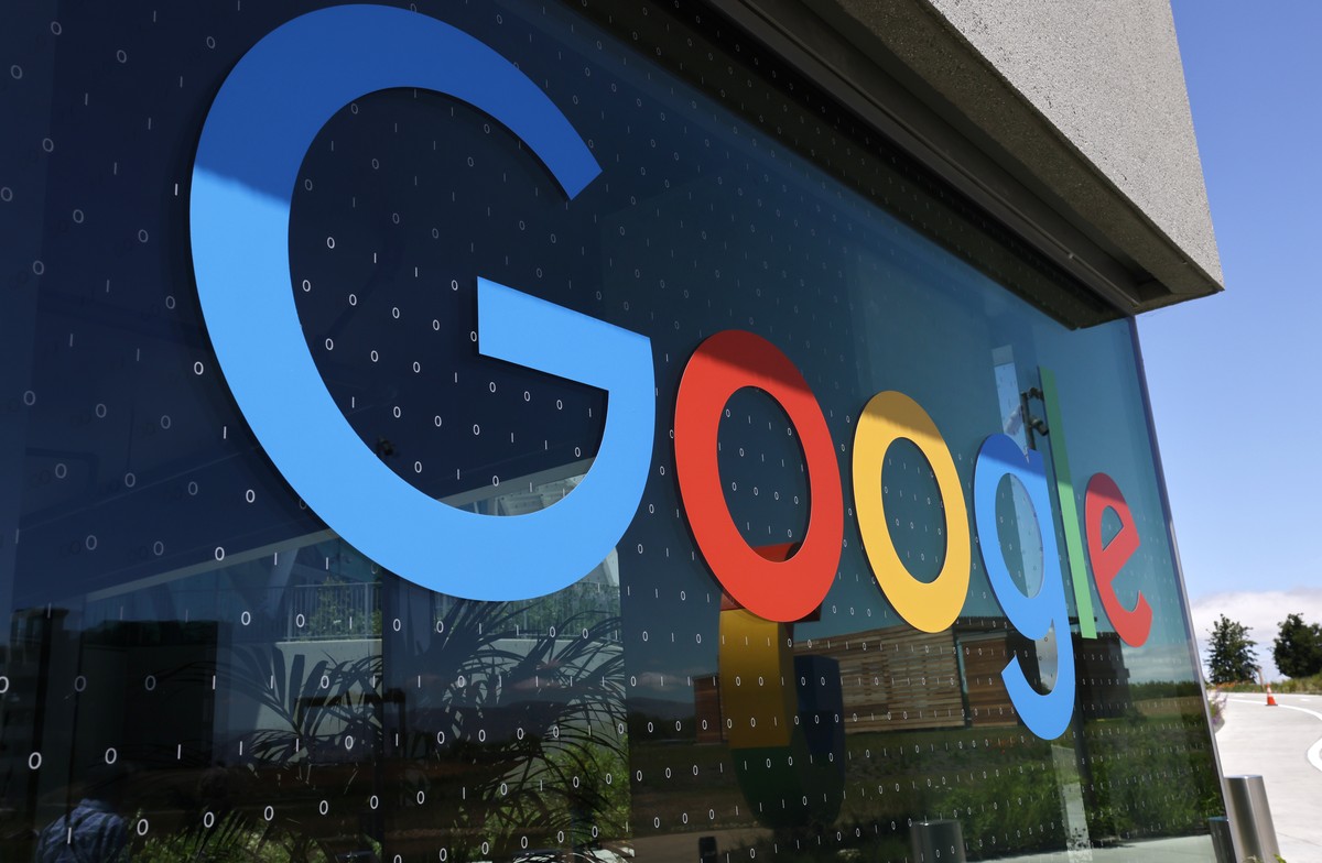 epa09952080 Google logo and binary code on the window of Google's new Bay View campus building, BV100 and during a media tour in Mountain View, California, USA, 16 May 2022. Google announced on 1 ...