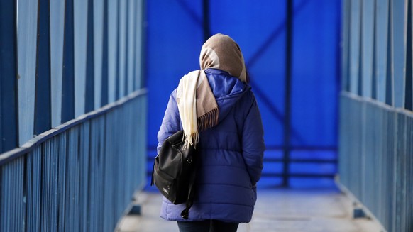 epa10398200 An Iranian woman walks on a pedestrian bridge in Tehran, Iran, 10 January 2023. According to Isna news agency Attorney General of the country has ordered Iranian police to &quot;firmly pun ...