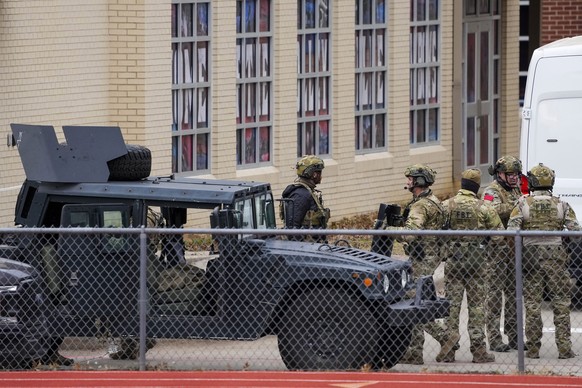 Law enforcement teams stage near Congregation Beth Israel while conducting SWAT operations in the 6100 block of Pleasant Run Road on Saturday, Jan. 15, 2022, in Colleyville, Texas. Authorities said a  ...