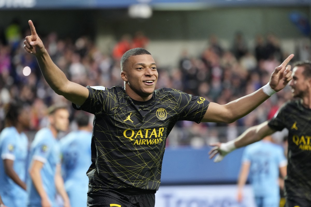 FILE - PSG's Kylian Mbappe celebrates after scoring his side's opening goal during the French League One soccer match between Troyes and Paris Saint Germain, at the Stade de l'Aube, in  ...