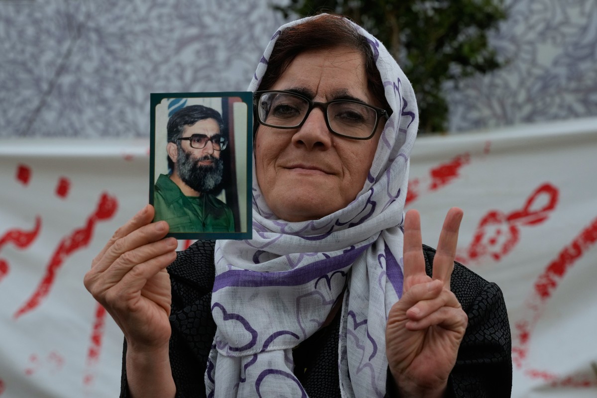 A woman holds a picture of the late Iranian Supreme Leader Ayatollah Ali Khamenei, who was killed in the U.S. and Israel strikes on Feb. 28, during a campaign in support of the government at the Enqel ...