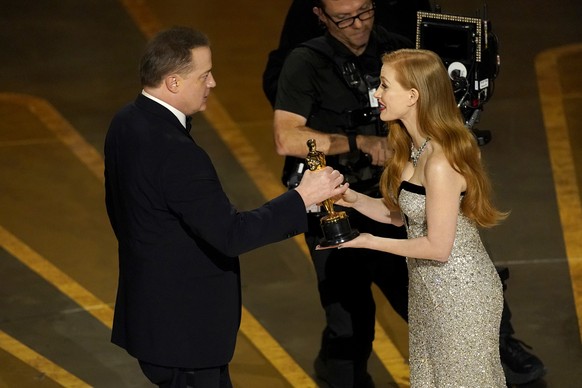 Jessica Chastain, right, presents Brendan Fraser with the award for best performance by an actor in a leading role for &quot;The Whale&quot; at the Oscars on Sunday, March 12, 2023, at the Dolby Theat ...