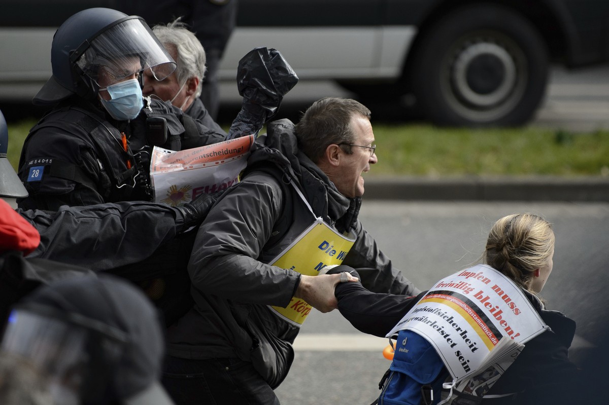 Police forces are on duty at a rally under the motto "Free citizens Kassel - basic rights and democracy" in Kassel, Germany, Saturday, March 20, 2021. According to police, several thousand p ...
