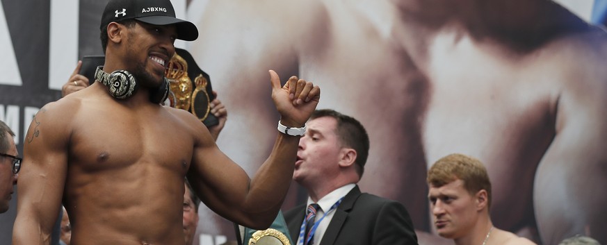 Britain&#039;s Anthony Joshua, left, and Russia&#039;s Alexander Povetkin, right, pose during the weigh-in at the Business Design Centre in London, Friday, Sept. 21, 2018. Anthony Joshua and Alexander ...