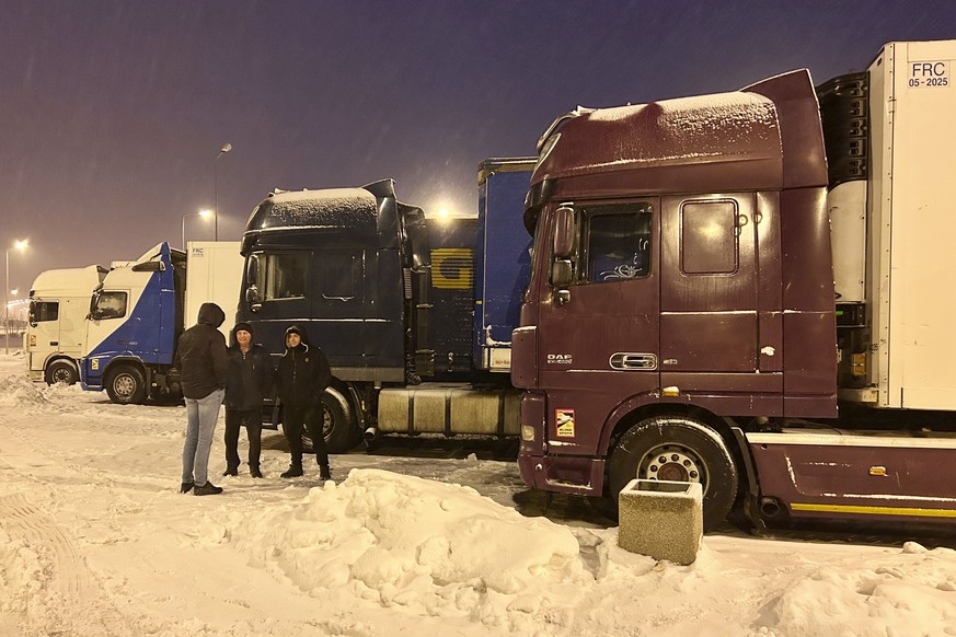 Ukrainian truck drivers wait to cross from Poland back into Ukraine in Korczowa, Poland, on Thursday Dec. 7, 2023. Ukrainian charities and companies supplying the country?s military warn that problems ...