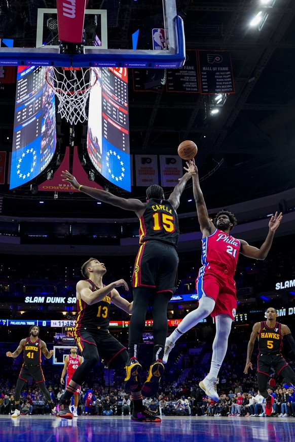 Philadelphia 76ers&#039; Joel Embiid, right, shoots with Atlanta Hawks&#039; Clint Capela, center, defending during the first half of an NBA basketball game Friday, Dec. 8, 2023, in Philadelphia. (AP  ...