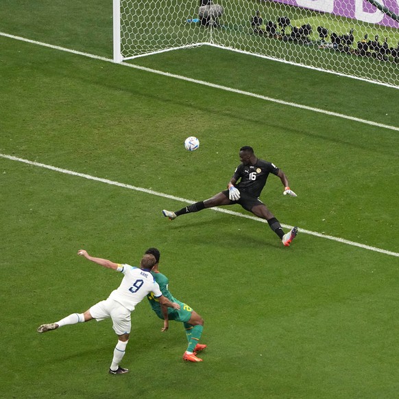 England&#039;s Harry Kane, left, scores his side&#039;s 2nd goal during the World Cup round of 16 soccer match between England and Senegal, at the Al Bayt Stadium in Al Khor, Qatar, Sunday, Dec. 4, 20 ...