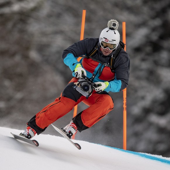 epa07358643 Former ski racer Bruno Kernen from Switzerland speeds down the slope filming for Swiss TV with a camera on his helmet ahead of the Women's Downhill race at the FIS Alpine Skiing World ...