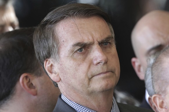 Brazil&#039;s President-elect Jair Bolsonaro listens to a reporter&#039;s question during an interview, outside his office of transition, in Brasilia, Brazil, Wednesday, Nov. 28, 2018. Bolsonaro will  ...