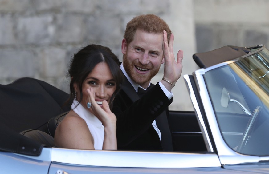 FILE - In this Saturday, May 19, 2018 file photo the newly married Duke and Duchess of Sussex, Meghan Markle and Prince Harry, leave Windsor Castle in a convertible car after their wedding in Windsor, ...