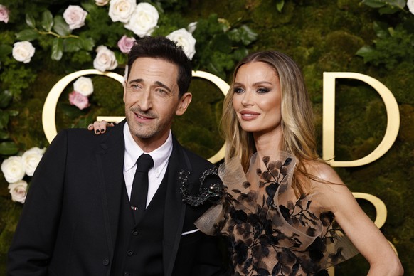 epa11808199 Adrien Brody (L) and Georgina Chapman (R) arrive for the 82nd annual Golden Globe Awards ceremony at the Beverly Hilton Hotel in Beverly Hills, California, USA, 05 January 2025. Artists in ...