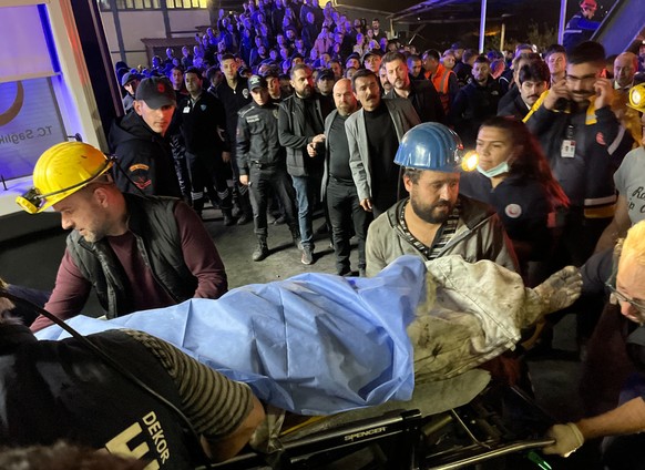 Miners carry the body of a victim in Amasra, in the Black Sea coastal province of Bartin, Turkey, Friday, Oct. 14, 2022. An official says an explosion inside a coal mine in northern Turkey has trapped ...