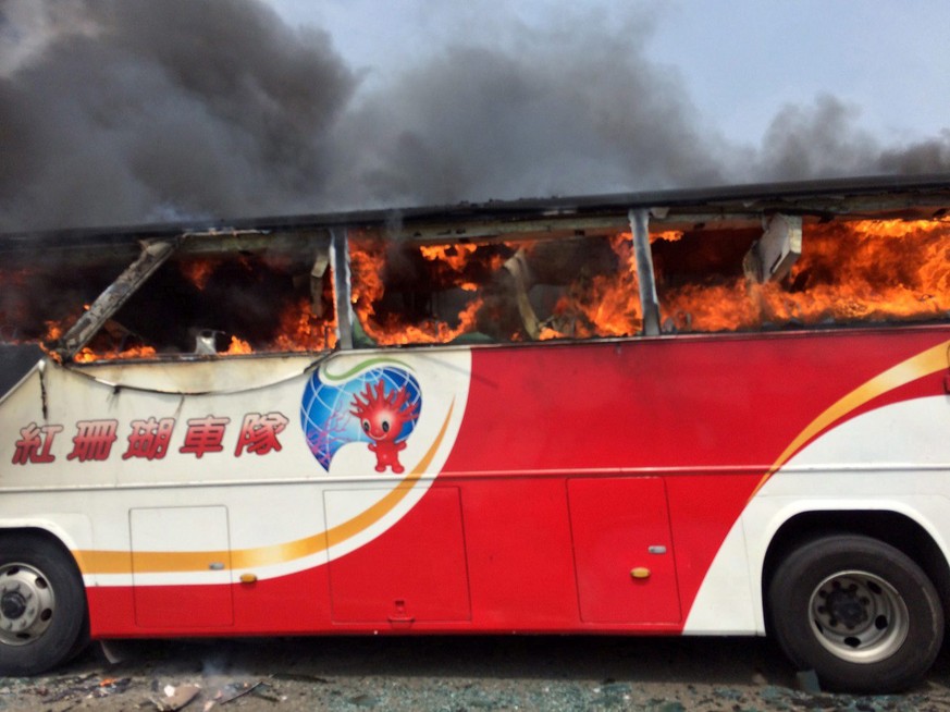 epa05431486 A handout photo released by the Taoyuan City Fire Department shows a tourist coach near the Taoyuan Internatinal Airport outside Taipei, Taiwan, 19 July 2016. All 26 people on board - 24 C ...