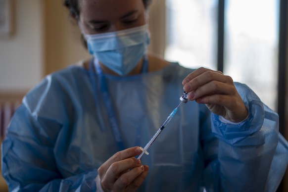 A nurse prepares the Pfizer-BioNTech COVID-19 vaccine for residents at Icaria nursing home in Barcelona, Spain, Tuesday, Jan. 12, 2021. Spain&#039;s rate of infection has shot up to 435 cases per 100, ...