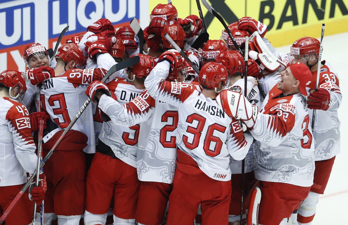 Players of Denmark celebrate after winning the Ice Hockey World Championships group B match between Finland and Denmark at the Jyske Bank Boxen arena in Herning, Denmark, Wednesday, May 9, 2018. (AP P ...