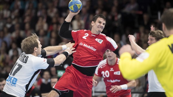 Swiss Andy Schmid, center, in action against Germany&#039;s Uwe Gensheimer, right, during the Handball EHF Euro 2018 qualification game between Switzerland and Germany in Zurich, Switzerland, Saturday ...