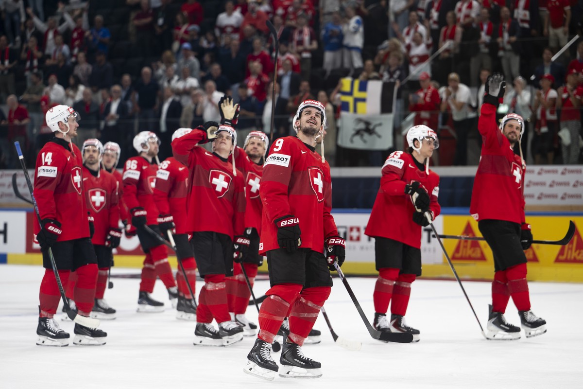 Switzerland's players celebrate after the 2026 IIHF Men's Ice Hockey World Championship preliminary round group A game between Switzerland and Finland, at the Swiss Life Arena ice hockey sta ...