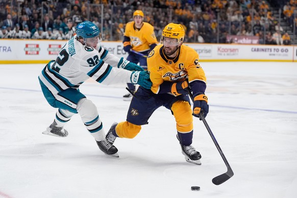 Nashville Predators defenseman Roman Josi (59) skates the puck past San Jose Sharks left wing Igor Chernyshov (92) during the second period of an NHL hockey game Tuesday, March 24, 2026, in Nashville, ...