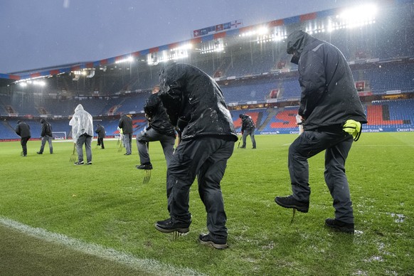 epa06324886 Staff members work under heavy rain to evacuate water from the field, prior to the 2018 Fifa World Cup play-offs second leg soccer match Switzerland against Northern Ireland at the St. Jak ...