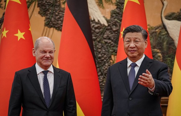 epa10285822 President of China Xi Jinping (R) welcomes German Chancellor Olaf Scholz (L) in the East Hall of the Great Hall of the People in Beijing, China, 04 November 2022. German Chancellor Scholz  ...