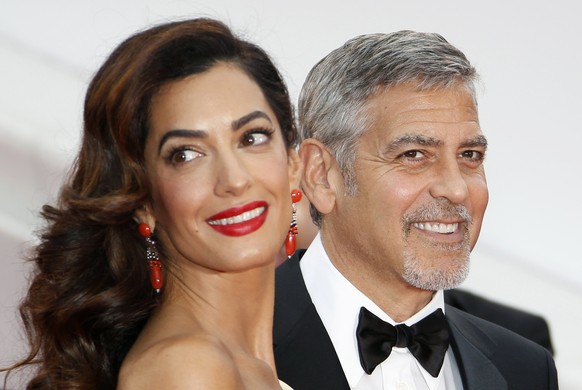 epa06013466 (FILE) A file photograph showing US actor George Clooney (R) and wife British human rights barrister Amal Clooney (L) arriving for the screening of &#039;Money Monster&#039; during the 69t ...