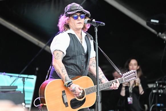 epa10022746 US actor Johnny Depp performs on stage at the Helsinki Blues Festival, Finland, 19 June 2022. EPA/KIMMO BRANDT